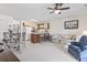 Cozy living room open to kitchen with breakfast bar, ceiling fan, and neutral carpet at 500 Fairway Village Dr. # J-7, Myrtle Beach, SC 29588