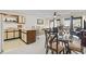 An open concept living room featuring a small kitchen, dining area, and carpet flooring at 500 Fairway Village Dr. # J-7, Myrtle Beach, SC 29588