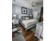 Comfortable bedroom with gray walls, wood floors, ceiling fan and ensuite bathroom at 503 20Th Ave. N # 3B, North Myrtle Beach, SC 29582