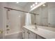 Bright bathroom with shower-tub, white vanity, and framed mirror at 5046 Belleglen Court # 202, Myrtle Beach, SC 29579