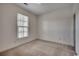 Bedroom with neutral carpet, one window, and an electrical outlet at floor level at 5046 Belleglen Court # 202, Myrtle Beach, SC 29579