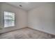 Bedroom with neutral carpet, one window, and an electrical outlet at floor level at 5046 Belleglen Court # 202, Myrtle Beach, SC 29579