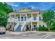Two story condo featuring dual balconies, covered entrances, stairs and parking spaces at 5046 Belleglen Court # 202, Myrtle Beach, SC 29579