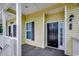 Well-lit covered porch with space for seating, including door with window and black shutters at 5046 Belleglen Court # 202, Myrtle Beach, SC 29579