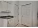 Neutral-toned hallway with white trim, storage cabinets and adjacent interior doors at 5046 Belleglen Court # 202, Myrtle Beach, SC 29579