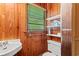 Cozy bathroom features wood-paneled walls, a sink, a toilet, and natural light at 506 28Th Ave. N, Myrtle Beach, SC 29577