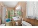 Full bathroom featuring wood paneled walls, a shower-tub combo, and modern fixtures at 506 28Th Ave. N, Myrtle Beach, SC 29577