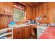 Charming kitchen features wood-paneled walls, vintage appliances, and ample natural light at 506 28Th Ave. N, Myrtle Beach, SC 29577