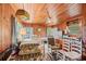 Spacious living room with wood-paneled walls, a ceiling fan, and natural light at 506 28Th Ave. N, Myrtle Beach, SC 29577
