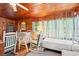 Cozy living room with bright natural light, wood-paneled walls, and a ceiling fan at 506 28Th Ave. N, Myrtle Beach, SC 29577
