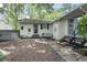 Backyard features a white house with blue door, a hot tub, and a small garden at 520 13Th Ave. N, Surfside Beach, SC 29575