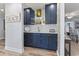 Stylish bar area with blue cabinets, glass shelving, and a marble countertop at 520 13Th Ave. N, Surfside Beach, SC 29575
