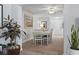 Bright dining room with a white table set for eight, plants, and neutral carpet at 520 13Th Ave. N, Surfside Beach, SC 29575