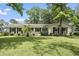 Charming single-story home with lush lawn, mature trees, and stylish black shutters at 520 13Th Ave. N, Surfside Beach, SC 29575