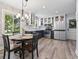 Modern kitchen with stainless steel appliances, stylish blue cabinets, and eat-in table at 520 13Th Ave. N, Surfside Beach, SC 29575