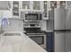 Close-up of the stainless steel appliances, white backsplash, and stylish blue cabinets at 520 13Th Ave. N, Surfside Beach, SC 29575