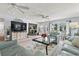 Bright living room with blue sofas, area rug, ceiling fans, and natural light at 520 13Th Ave. N, Surfside Beach, SC 29575
