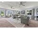 Inviting living room with blue sofas, rug, and large windows offering ample natural light at 520 13Th Ave. N, Surfside Beach, SC 29575