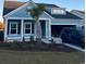 Attractive blue home with a well-manicured lawn, complete with a palm tree and an attached garage at 526 Magnolia Terrace Dr, Myrtle Beach, SC 29579