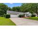 Exterior view of a home featuring an attached garage, mature trees and manicured landscaping at 556 Crusade Circle, Conway, SC 29526