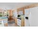 Bright kitchen featuring wooden cabinetry, white appliances and tile flooring at 556 Crusade Circle, Conway, SC 29526
