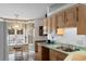 Bright kitchen featuring wooden cabinetry, a bay window and tile flooring at 556 Crusade Circle, Conway, SC 29526