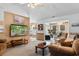 Spacious living area with a large TV, and seamless flow into sunroom and kitchen at 556 Crusade Circle, Conway, SC 29526