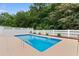 Backyard swimming pool surrounded by a white fence, landscaping and a concrete patio at 556 Crusade Circle, Conway, SC 29526