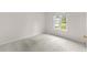 Bright, empty bedroom features neutral carpet, a window, and minimal fixtures creating a blank canvas at 583 Wildflower Trail, Myrtle Beach, SC 29579