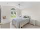 Bedroom with arched window offering natural light, ceiling fan and a serene atmosphere at 583 Wildflower Trail, Myrtle Beach, SC 29579
