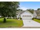 Charming single-story home with a manicured lawn, white siding, and attached garage at 583 Wildflower Trail, Myrtle Beach, SC 29579