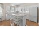 Bright kitchen with white cabinets, island with seating, and stainless steel appliances at 583 Wildflower Trail, Myrtle Beach, SC 29579