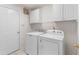 Functional laundry room with white cabinets, washer, and dryer for convenient chores at 583 Wildflower Trail, Myrtle Beach, SC 29579