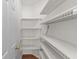 Walk-in pantry with white wire shelves and wood-look flooring, perfect for organized storage at 583 Wildflower Trail, Myrtle Beach, SC 29579