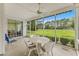 Relaxing screened porch with ceiling fan and view of the lush golf course at 583 Wildflower Trail, Myrtle Beach, SC 29579