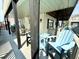 Deck with blue chairs, table and chairs, and white railings at 6001-B5 S Kings Hwy., Myrtle Beach, SC 29575