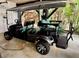 This golf cart is a four-seater with a roof and custom tires at 6001-B5 S Kings Hwy., Myrtle Beach, SC 29575