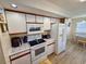 Kitchen featuring white appliances and cabinetry, with an eat-in area at 6001-B5 S Kings Hwy., Myrtle Beach, SC 29575