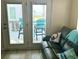 Cozy living room featuring a comfortable couch with a view of the ocean from the outdoor balcony at 6001-B5 S Kings Hwy., Myrtle Beach, SC 29575
