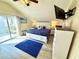 Enjoy natural light in this main bedroom with a king bed, dressers, and a view of the balcony from the sliding glass door at 6001-B5 S Kings Hwy., Myrtle Beach, SC 29575