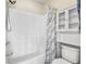 Bright bathroom featuring a shower-tub combo with shower curtain and built in storage at 611 2Nd Ave. S # 18-C, North Myrtle Beach, SC 29582