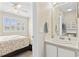 A well-lit bathroom sink and vanity with a view into a bright bedroom at 611 2Nd Ave. S # 18-C, North Myrtle Beach, SC 29582
