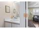 Cozy bathroom featuring a white vanity, framed mirror, and decorative artwork enhancing the space at 611 2Nd Ave. S # 18-C, North Myrtle Beach, SC 29582