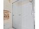 Bright white bathroom with glass enclosed shower and accessibility features at 611 2Nd Ave. S # 18-C, North Myrtle Beach, SC 29582