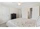 Neutral bedroom with ceiling fan and view into attached bathroom and closet at 611 2Nd Ave. S # 18-C, North Myrtle Beach, SC 29582