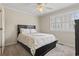Neutral colored bedroom featuring a bed, large window with shutters, and ceiling fan at 611 2Nd Ave. S # 18-C, North Myrtle Beach, SC 29582