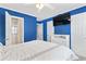 A vibrant bedroom with blue walls features a bed, TV, and ensuite bathroom for modern comfort at 611 2Nd Ave. S # 18-C, North Myrtle Beach, SC 29582
