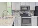 Modern kitchen features stainless steel appliances and granite countertops at 611 2Nd Ave. S # 18-C, North Myrtle Beach, SC 29582