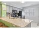 Bright kitchen features granite countertops, stainless steel appliances, and a mosaic tile backsplash at 611 2Nd Ave. S # 18-C, North Myrtle Beach, SC 29582