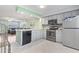 Open kitchen with stainless steel appliances and tile flooring at 611 2Nd Ave. S # 18-C, North Myrtle Beach, SC 29582